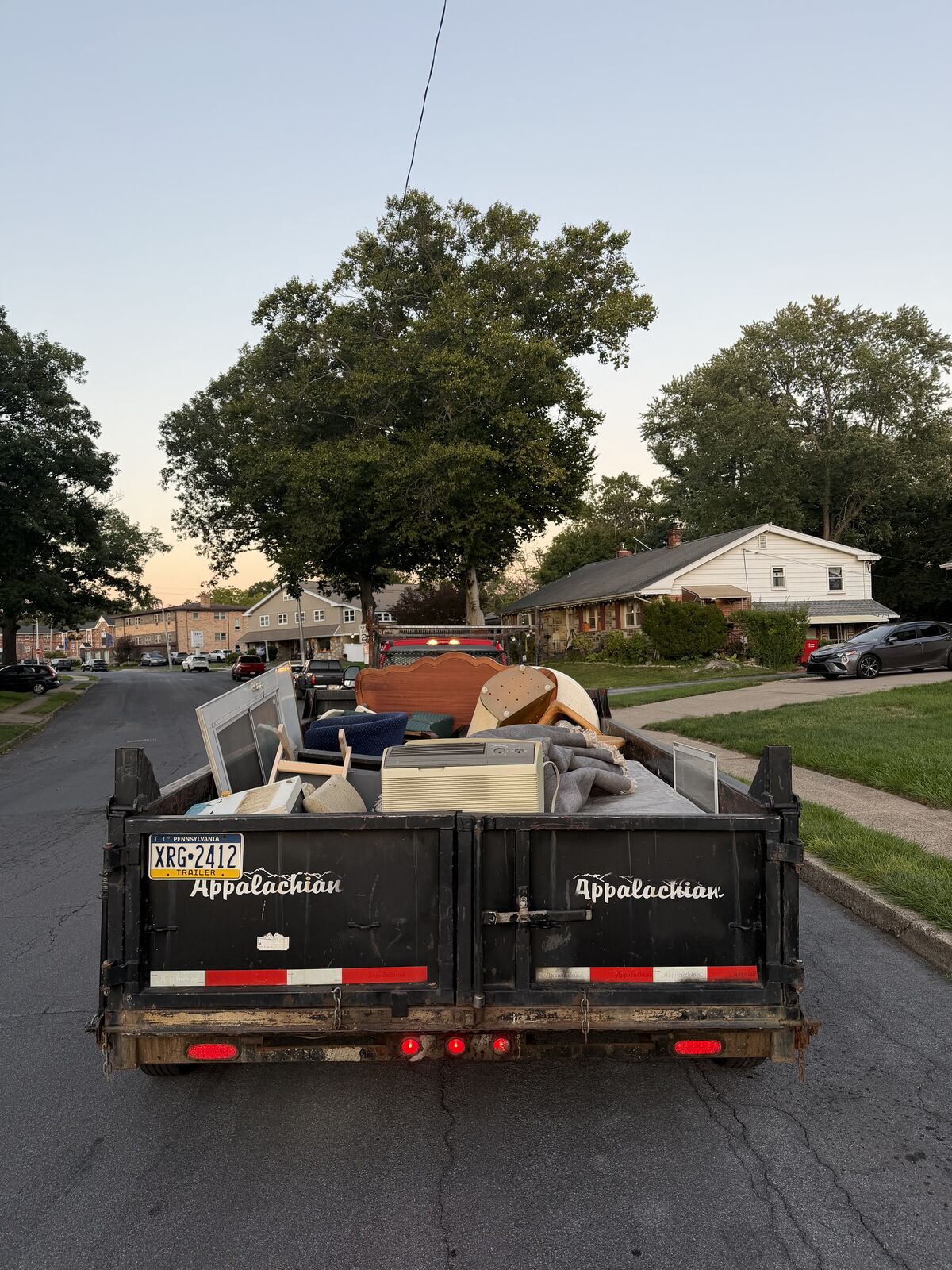 Trailer loaded with furniture, an air conditioner, and other household items for hauling